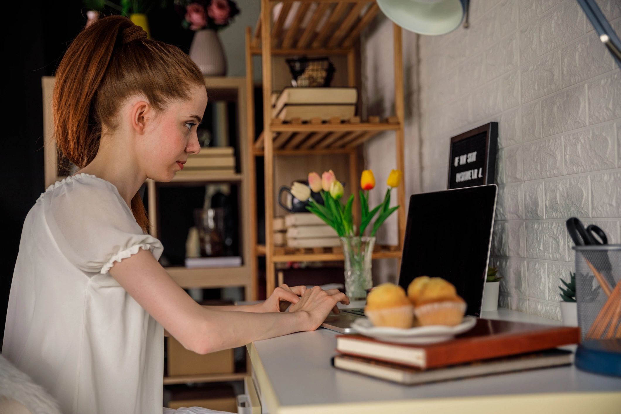 Person working at a desk with a laptop