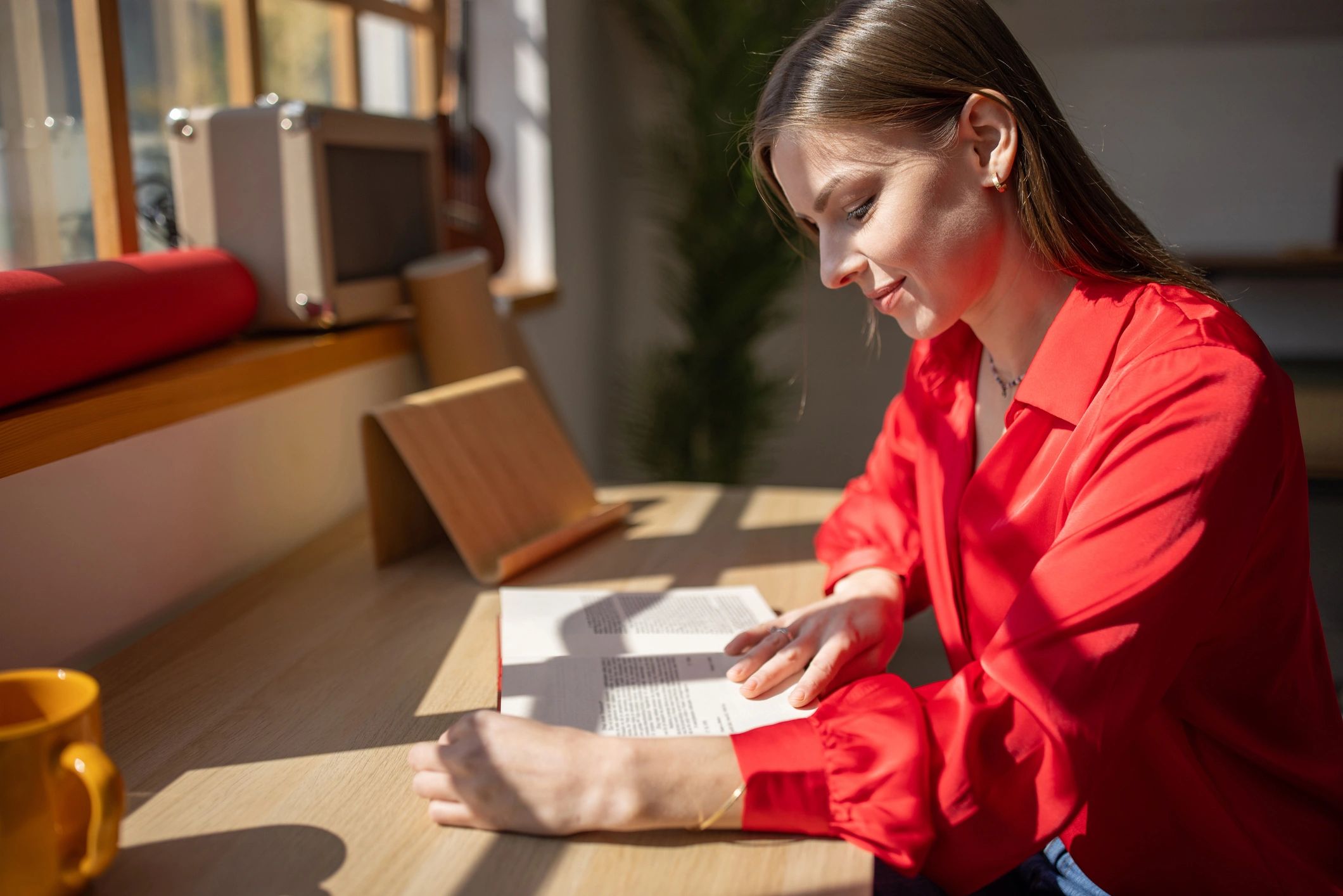 Person reading a book at home