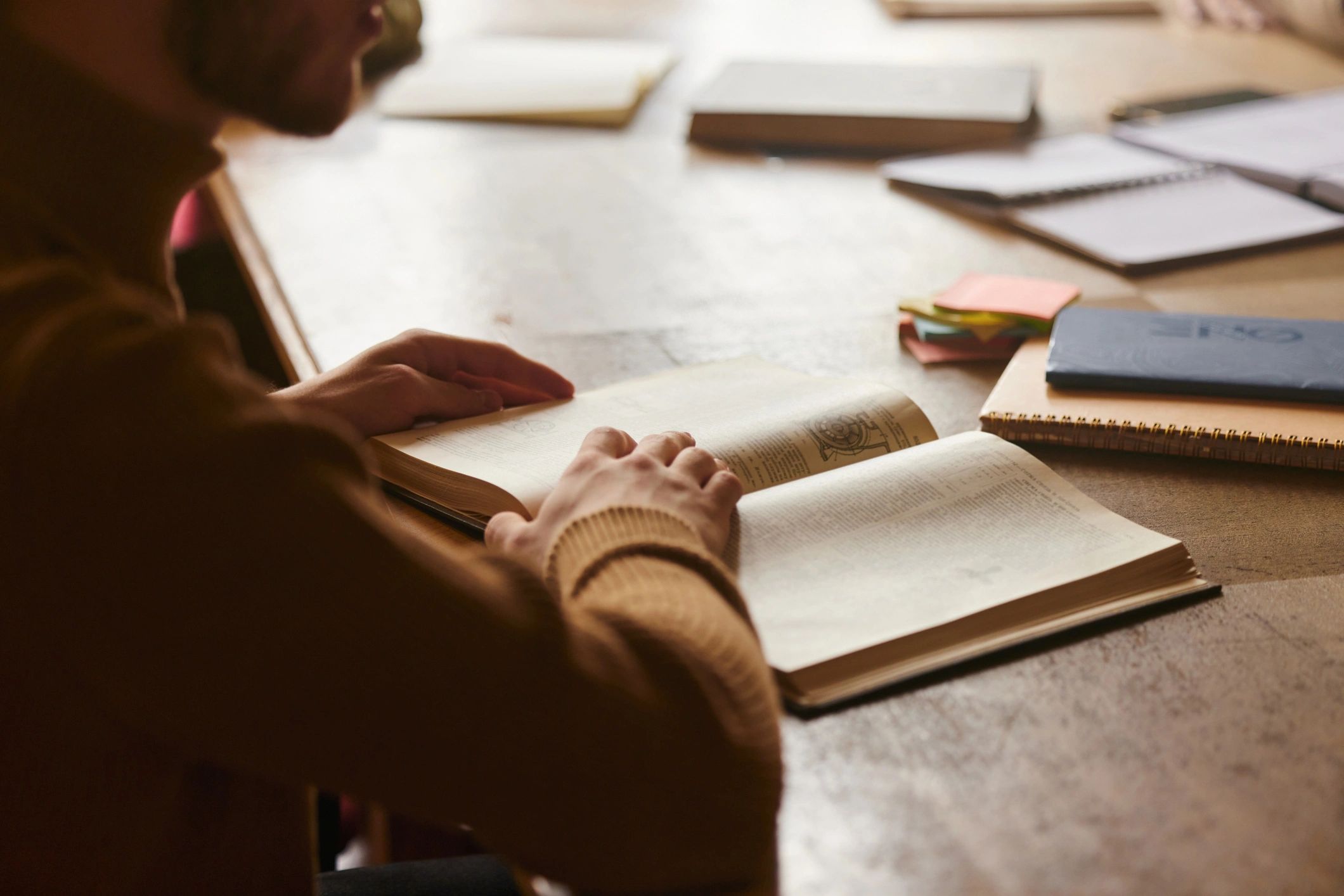Close-up of a person reading a book in a library
